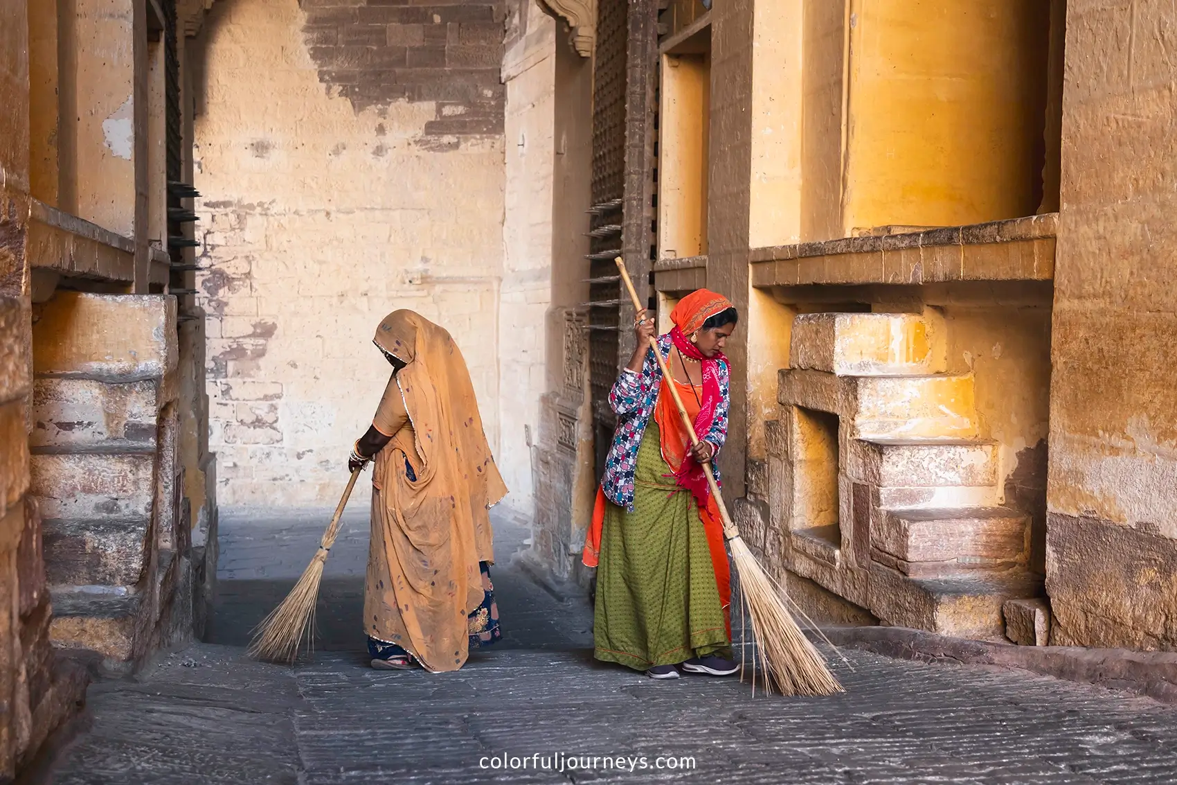 Women sweep the grounds at Mehrangarh Fort in Jodhpur, India