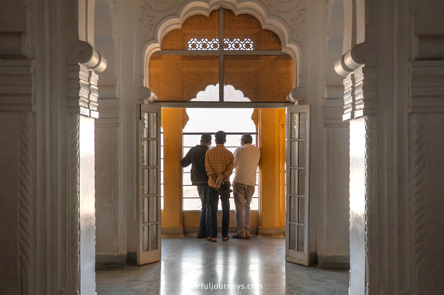 Men look out of a window at Mehrangarh Fort in Jodhpur, India
