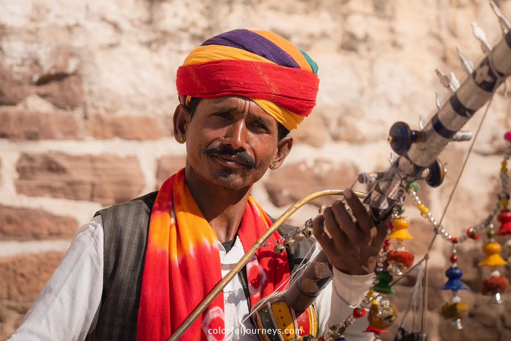 A man plays a traditional instrument at Mehrangarh Fort in Jodhpur, India