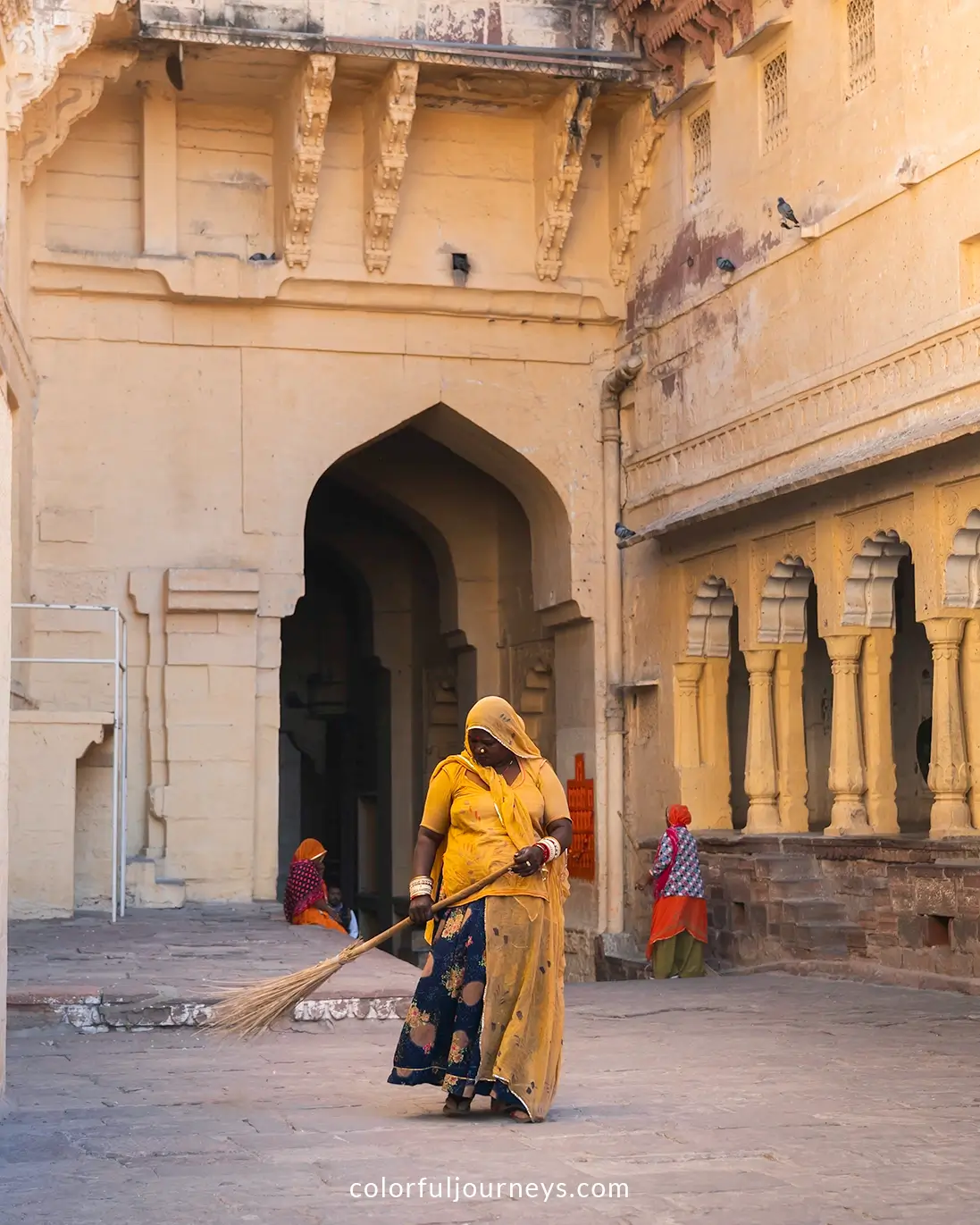 Women sweep the grounds at Mehrangarh Fort in Jodhpur, India