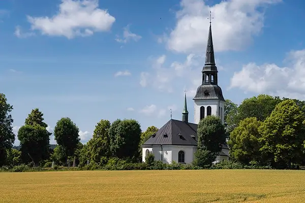 A church in front of a wheat field in Sweden