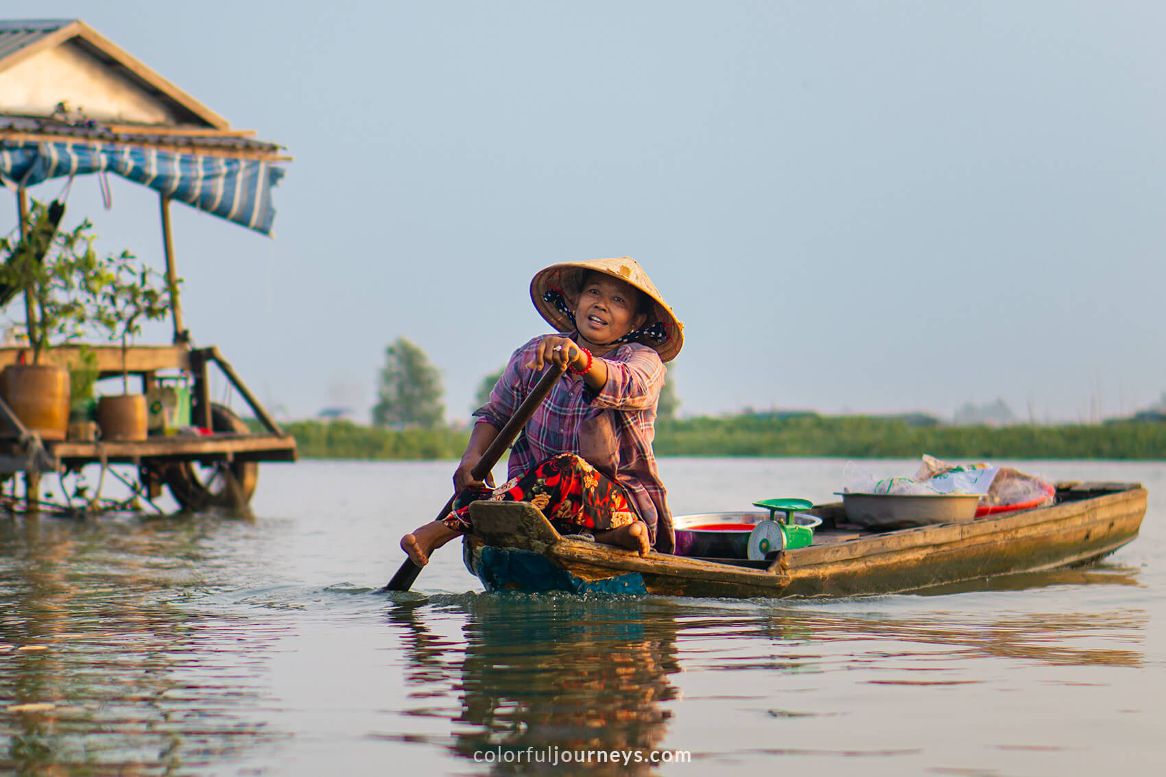 A woman paddles down the Long Xuyen floating market. 