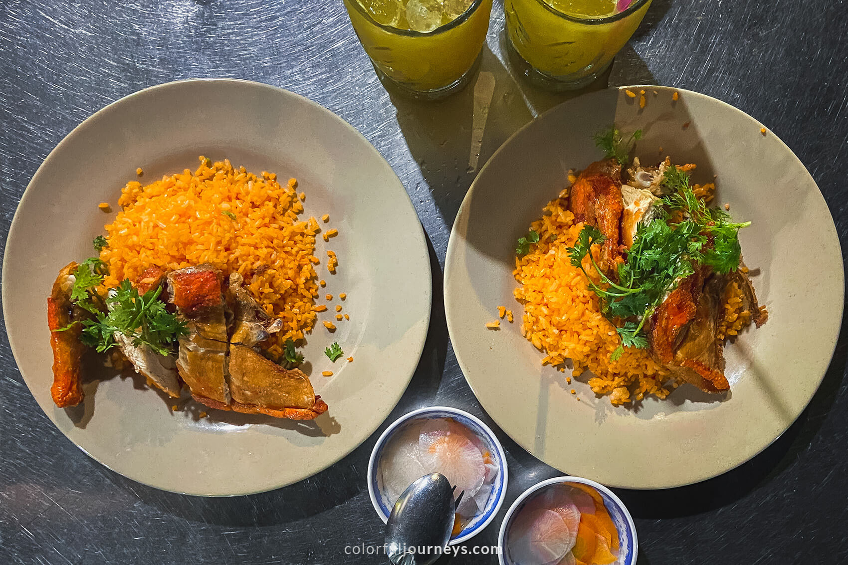 Two plates with chicken and rice.