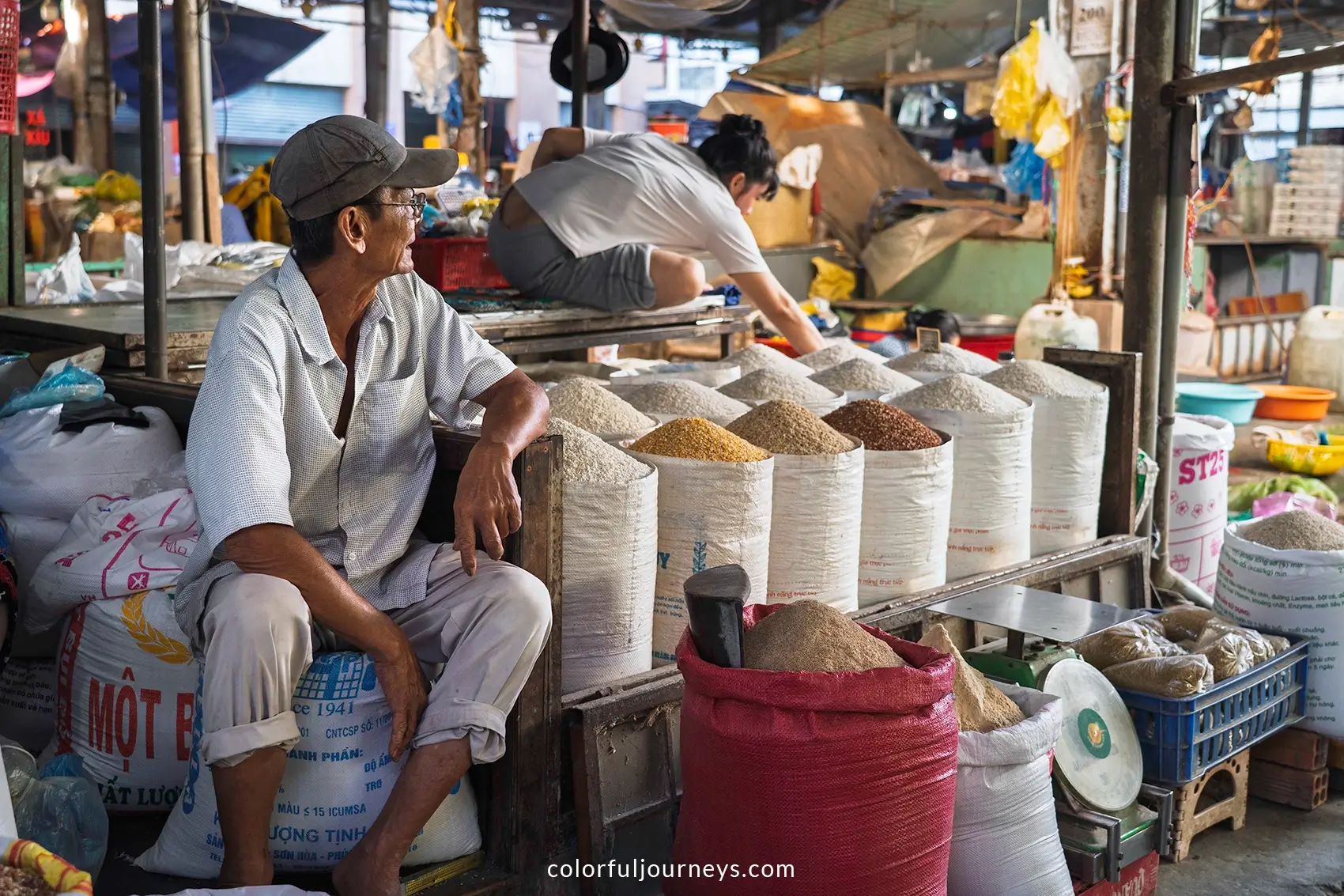 A man sells dried goods at a market in Vinh Long, Vietnam