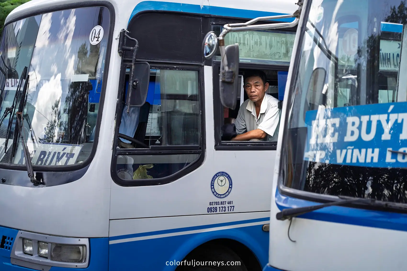 A man looks out the window of a bus in Vinh Long, Vietnam