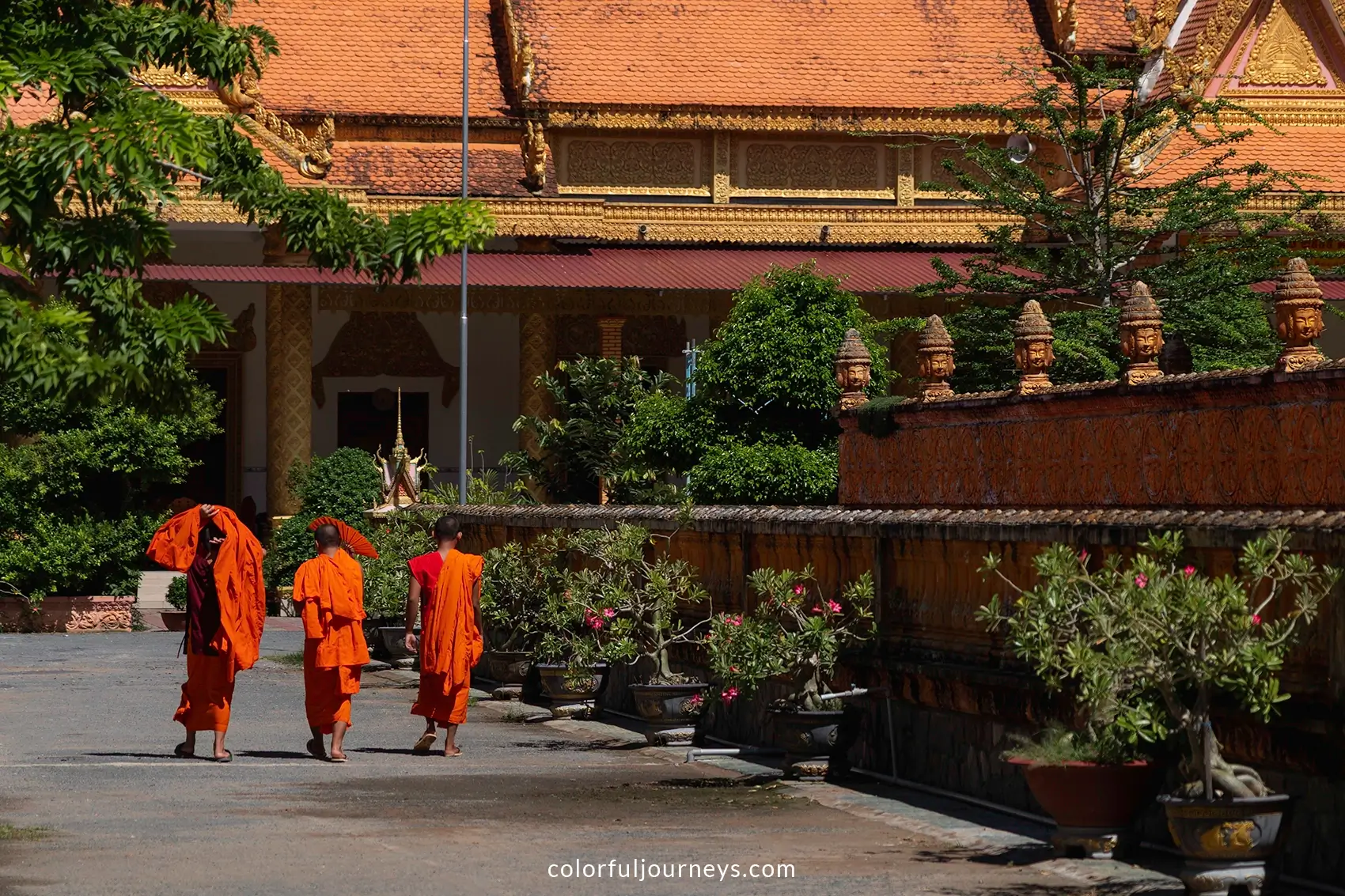Monks in orange robes at Kampong Ksan temple in Tra Vinh, Vietnam