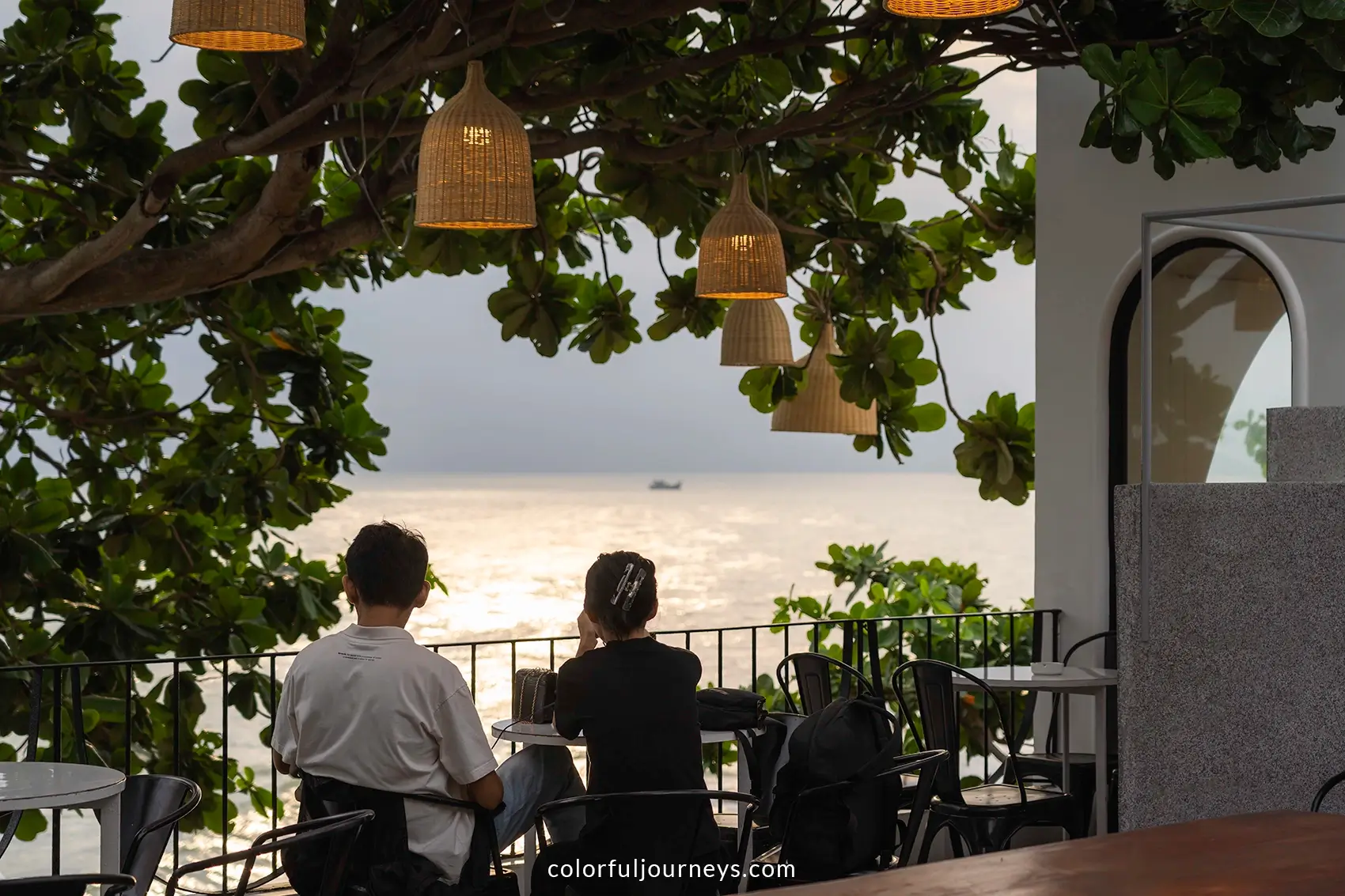 People look out over the ocean at a cafe in Vung Tau, Vietnam