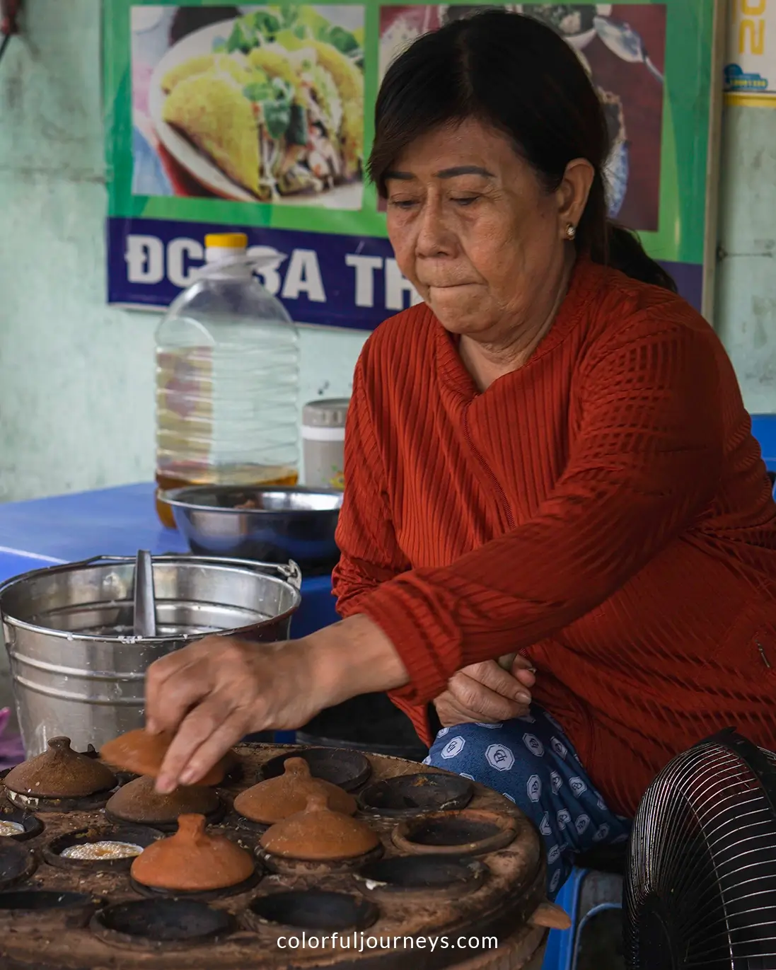 A woman prepares Banh Can in Nha Trang, Vietnam