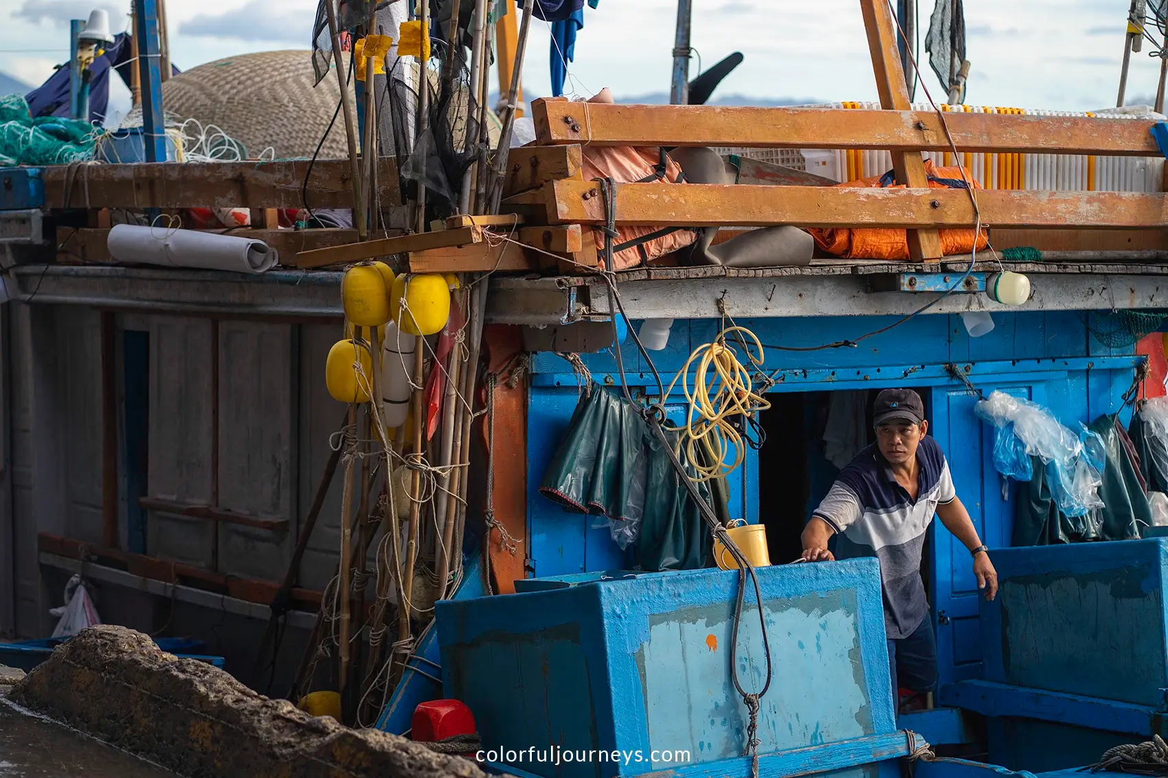 A fisherman on his wooden boat in Nha Trang, Vietnam