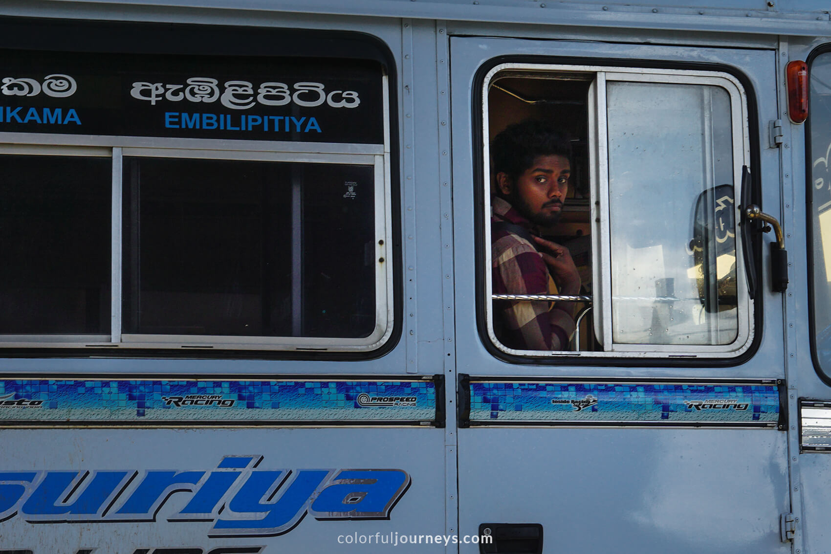A man looks through a bus window in Matara, Sri Lanka.