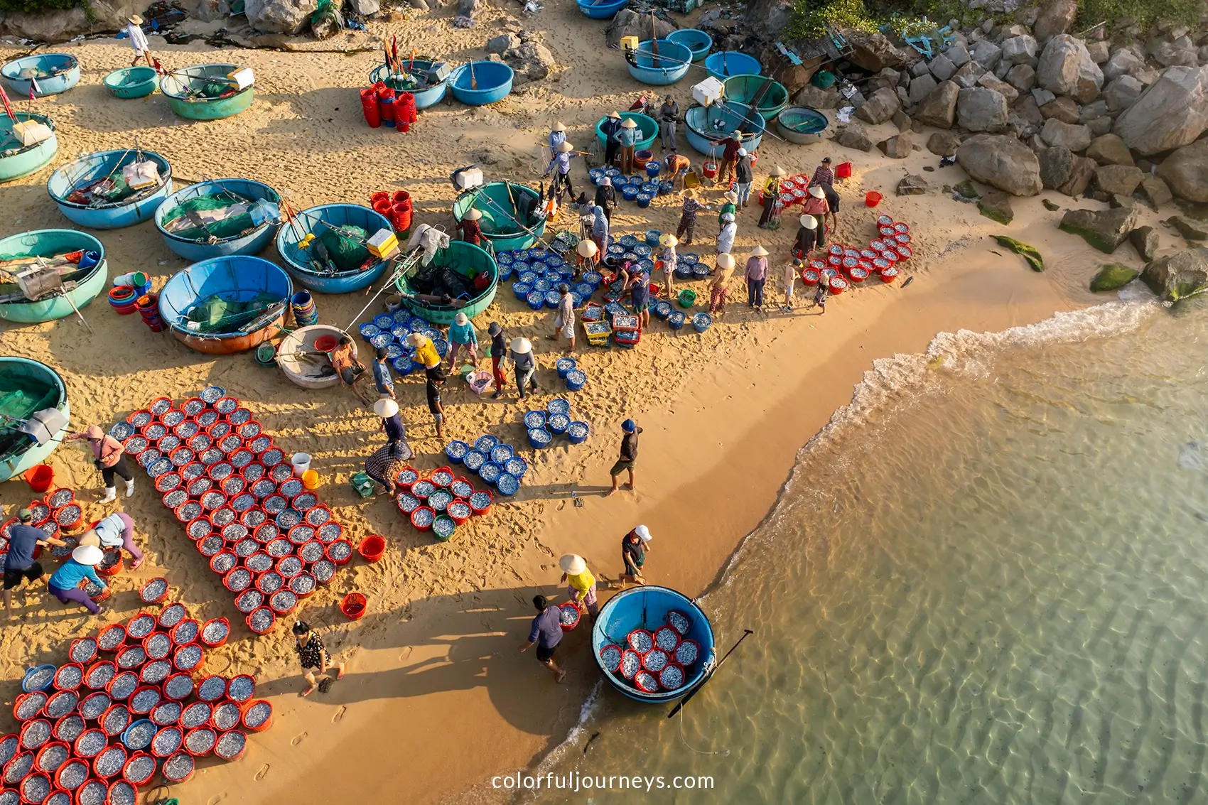 Buckets filled with fish at a fishing market on the beach. 