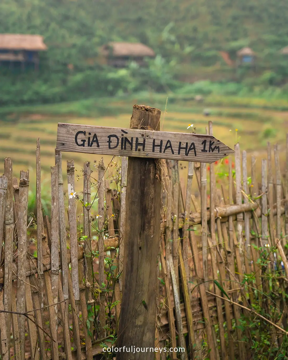 A wooden pole with a sign at Ban Lien Village