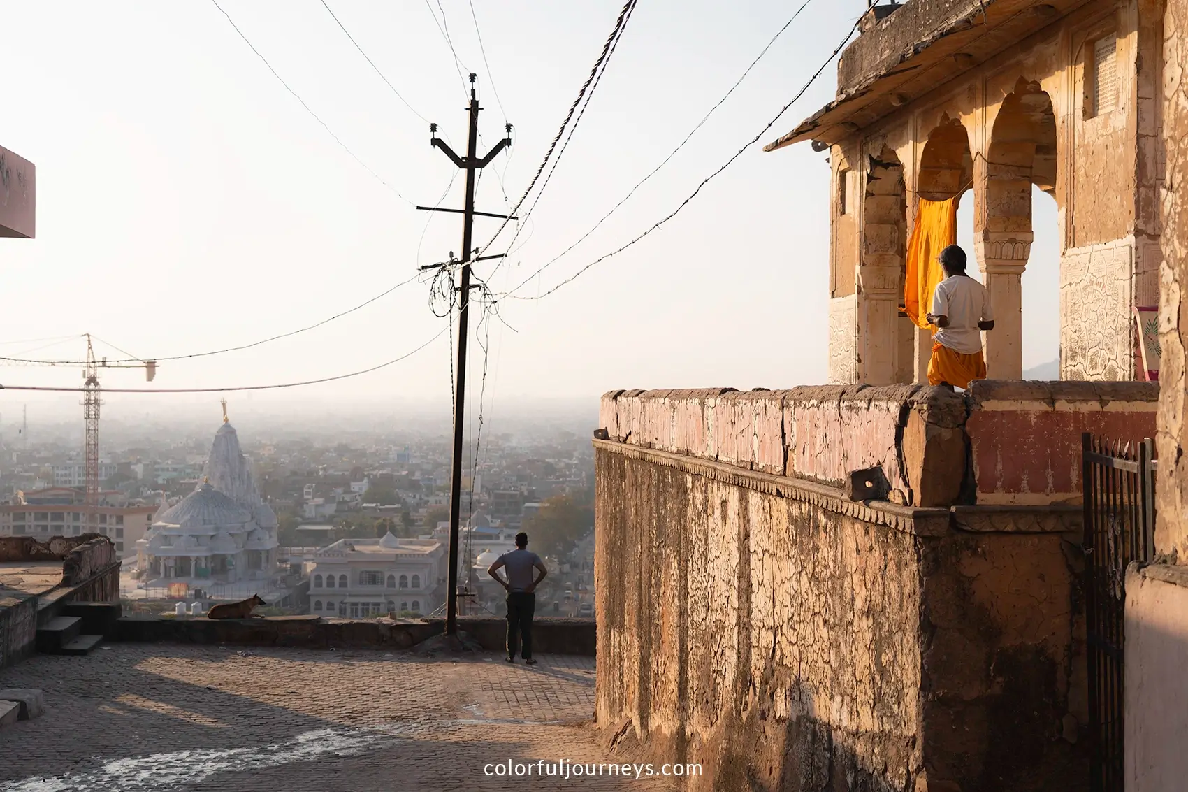 Men stand at a temple overlooking Jaipur, India