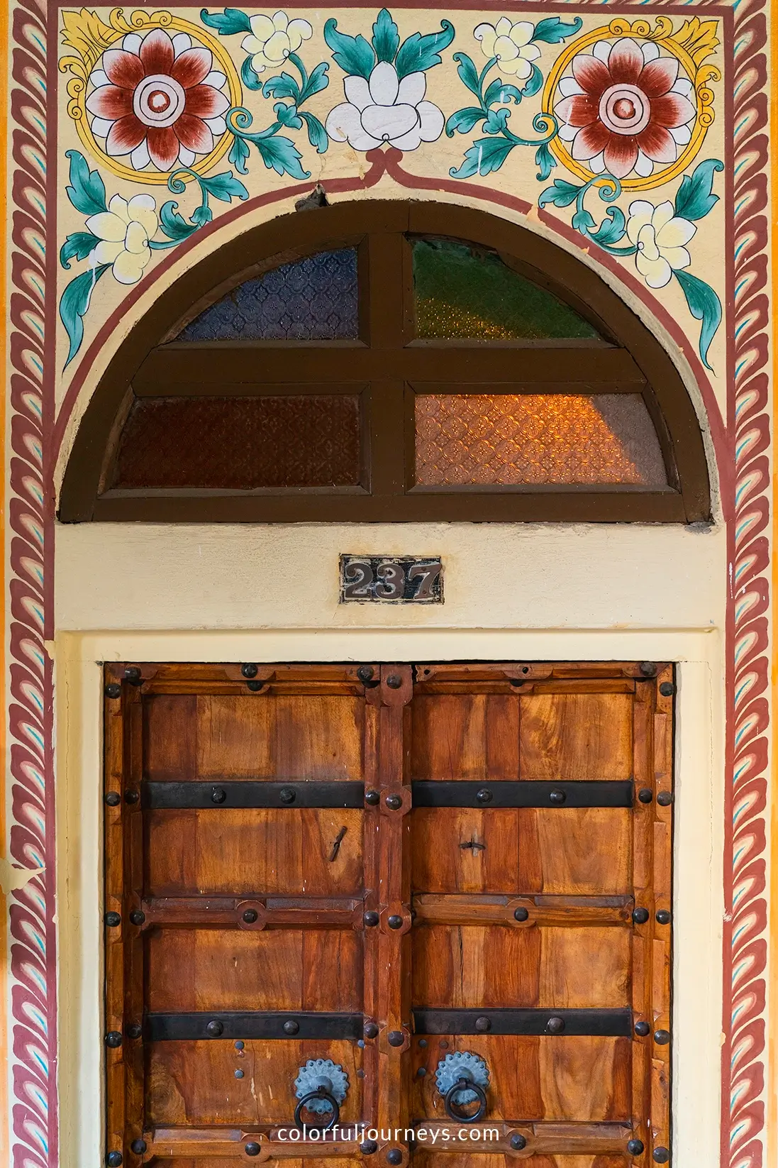 A wooden door to a room at a haveli in Jaipur, India