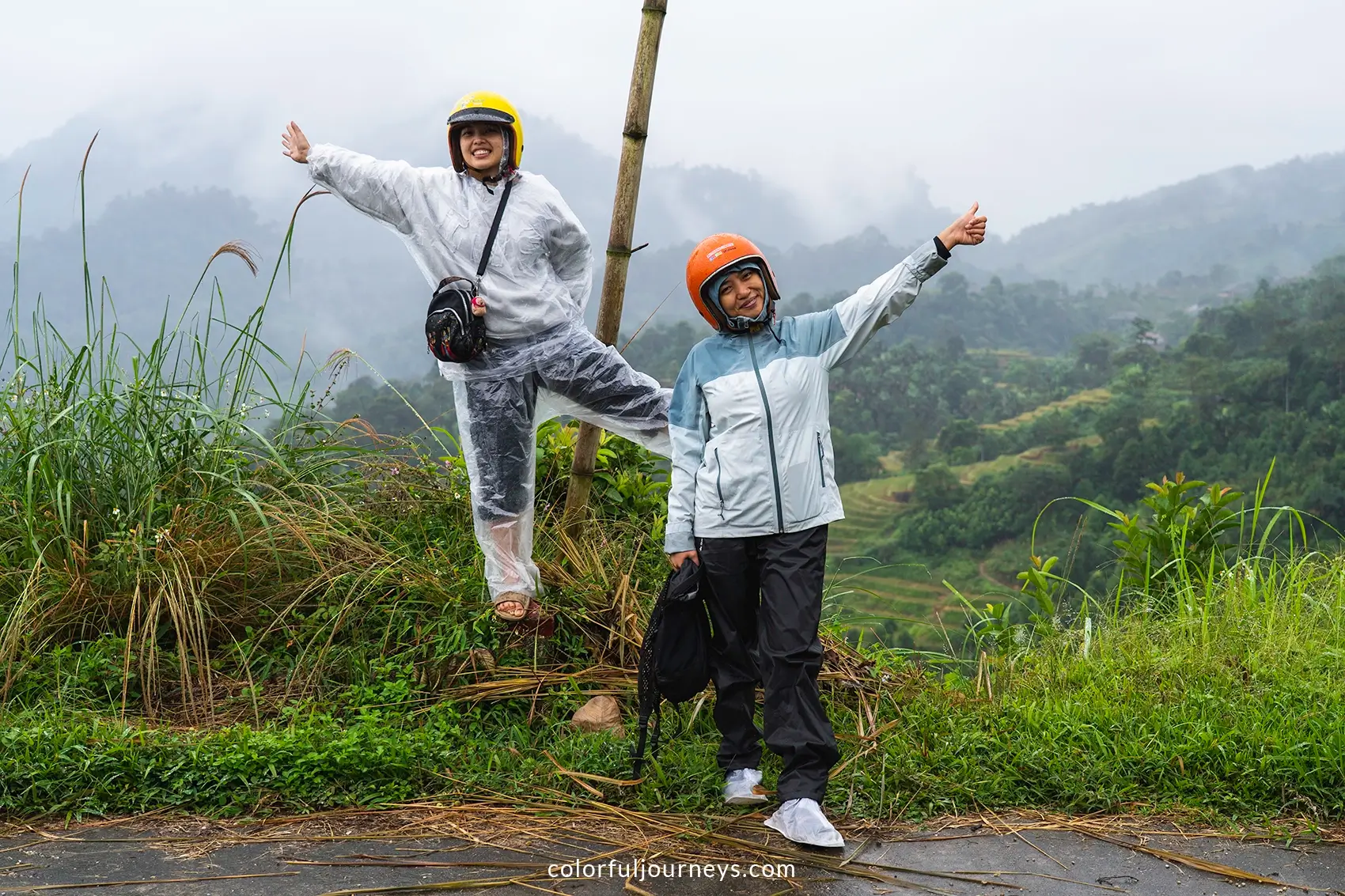 Two women pose for a photo in the rainy mountains of Ha Giang, Vietnam