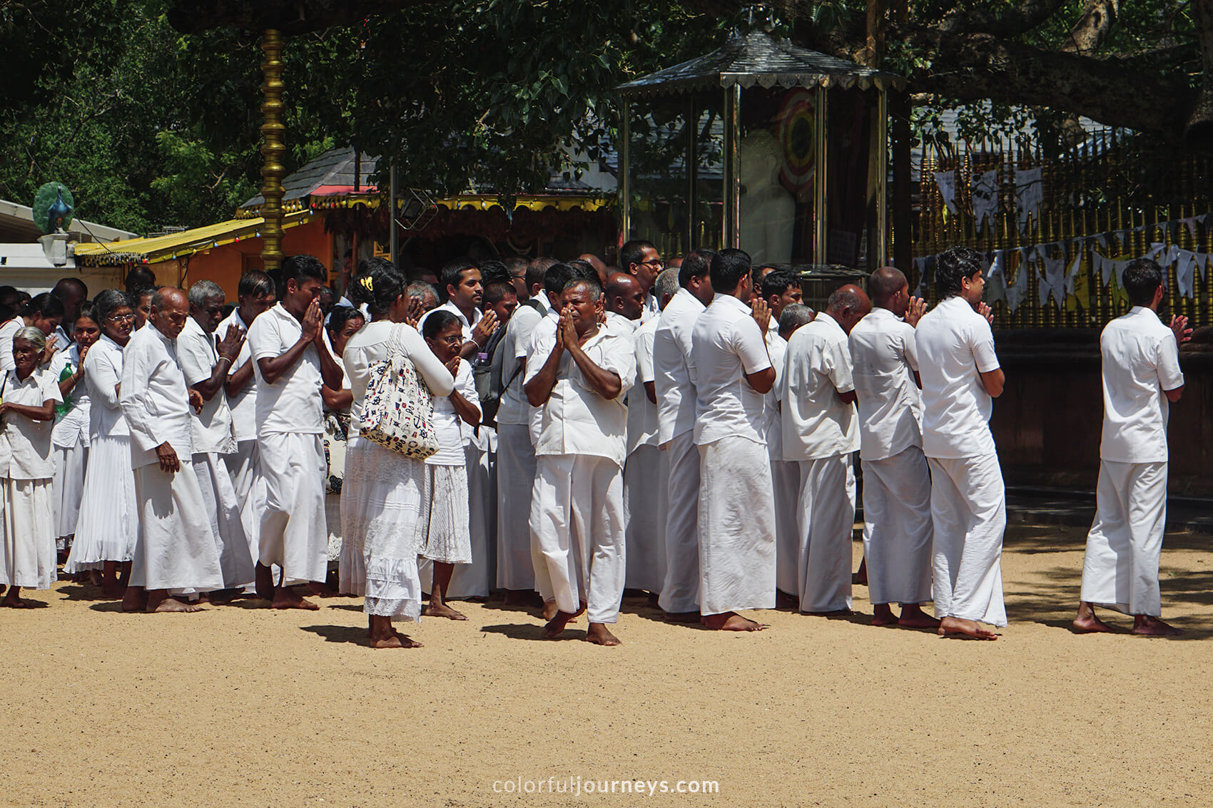 Locals dressed in white, paying there respect to Buddha. 