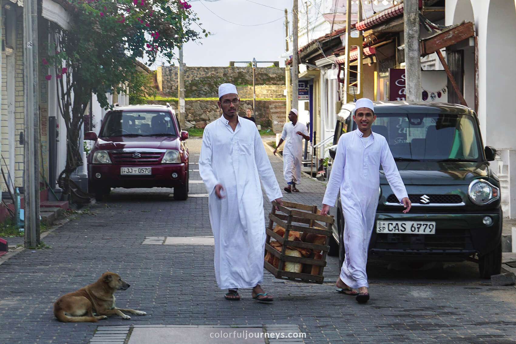 Two young men wearing white robes in Galle Fort, Sri Lanka.