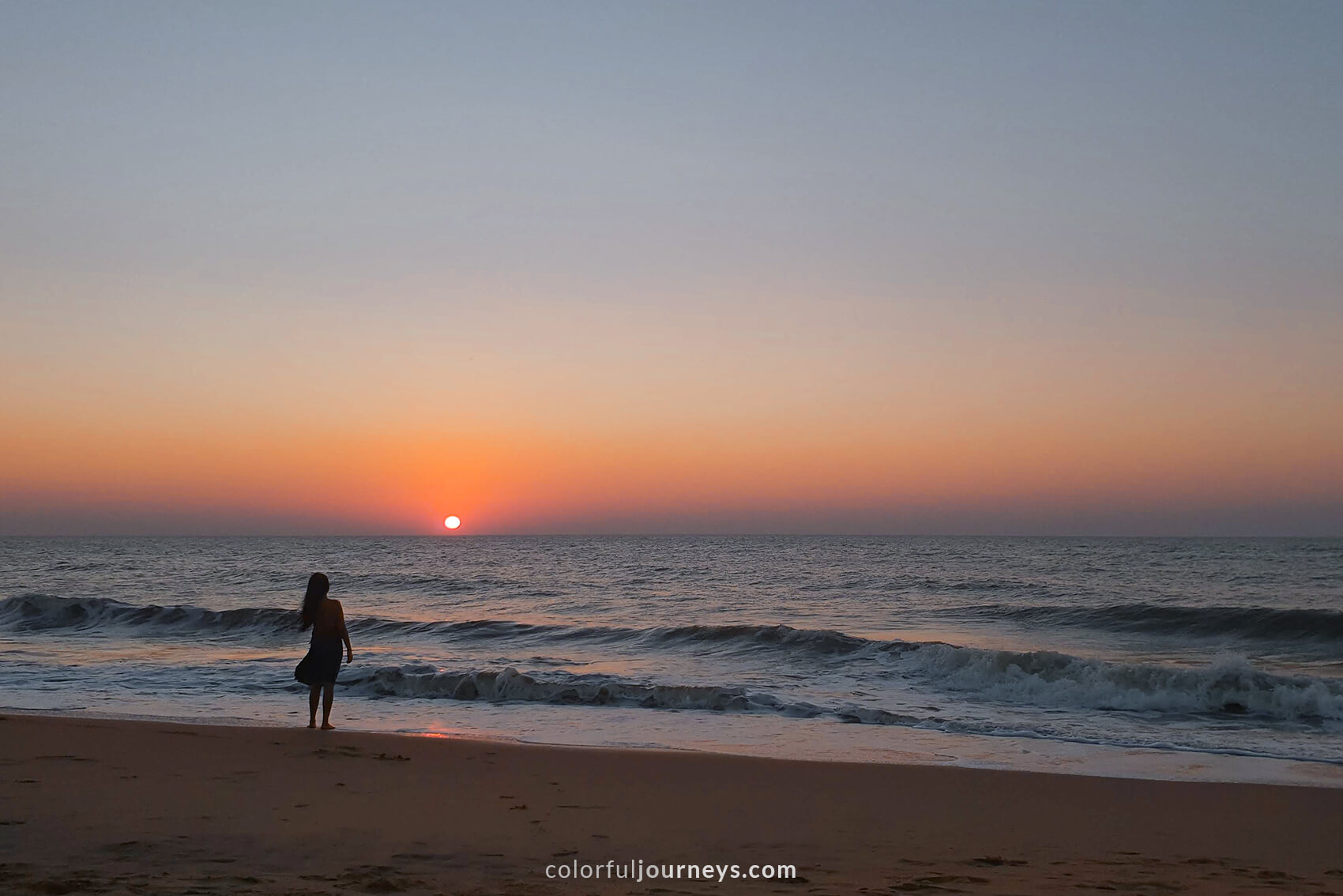 A woman at the beach during sunset in Negombo, Sri Lanka.