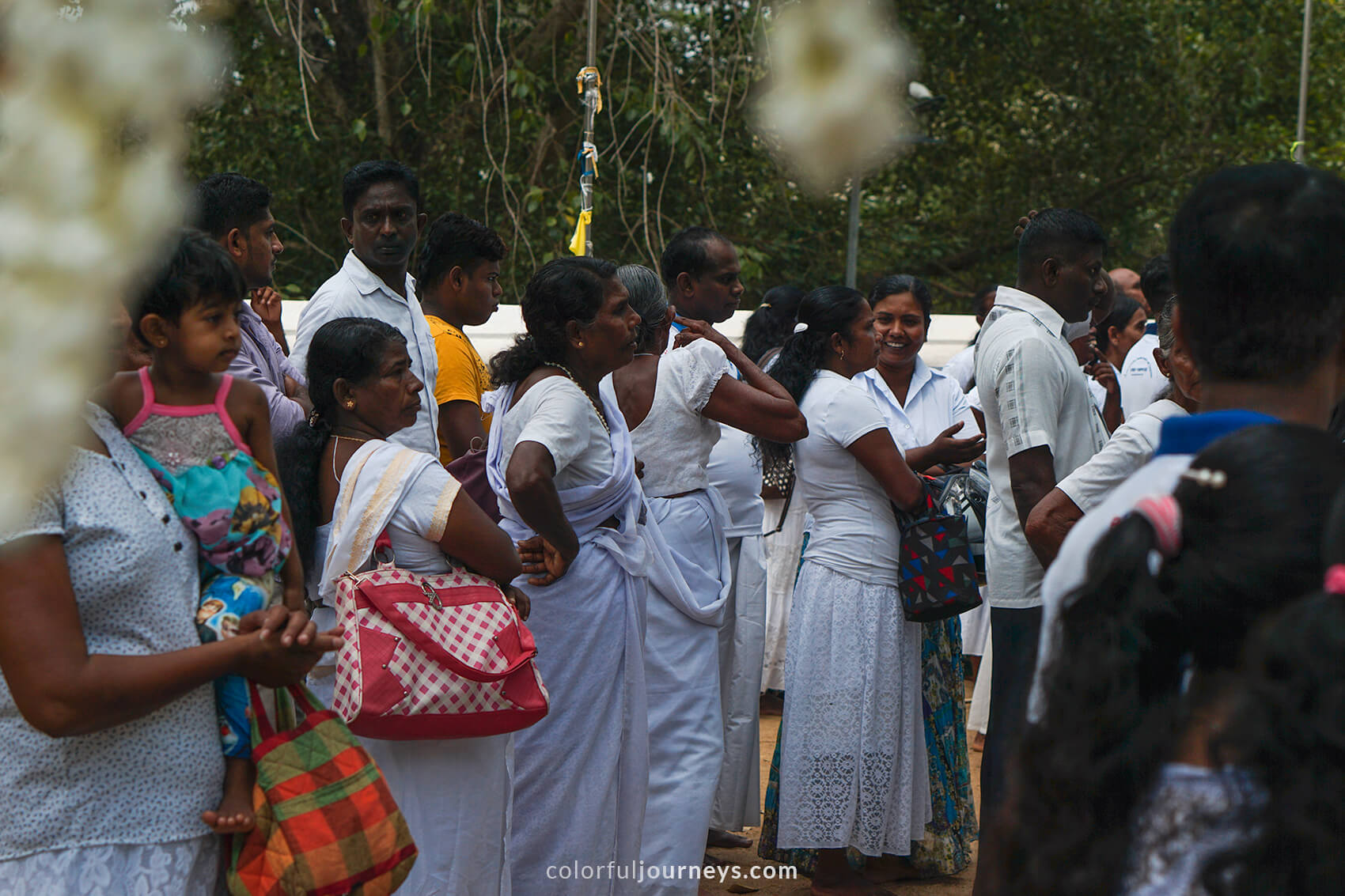 Locals dressed in white at a temple in Anuradhapura, Sri Lanka.