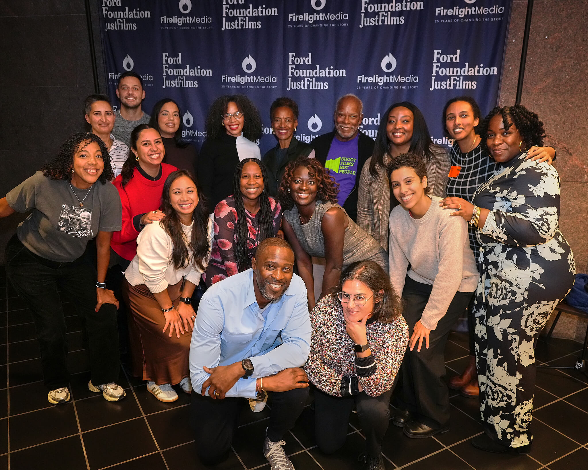 An image of 13 2021-2023 Documentary Lab Fellows posing together inside the Ace Hotel in New Orleans.
