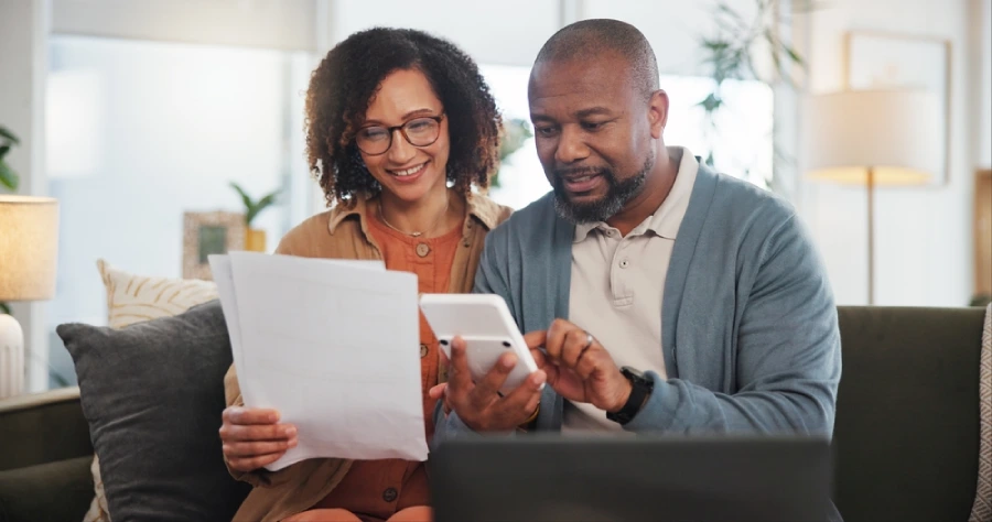 Senior couple with laptop, calculator and financial planning