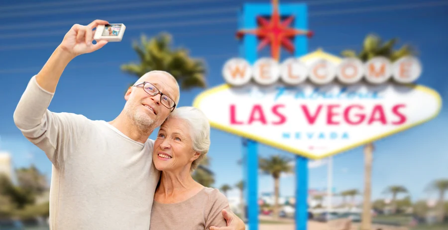 Senior couple in front of Las Vegas sign
