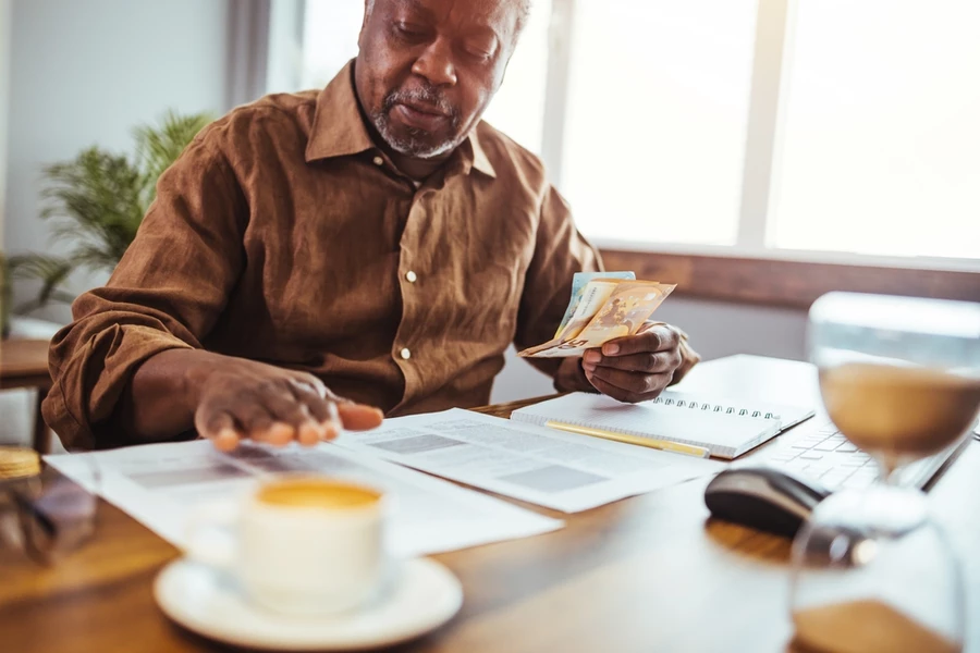 Angry senior man paying federal income taxes