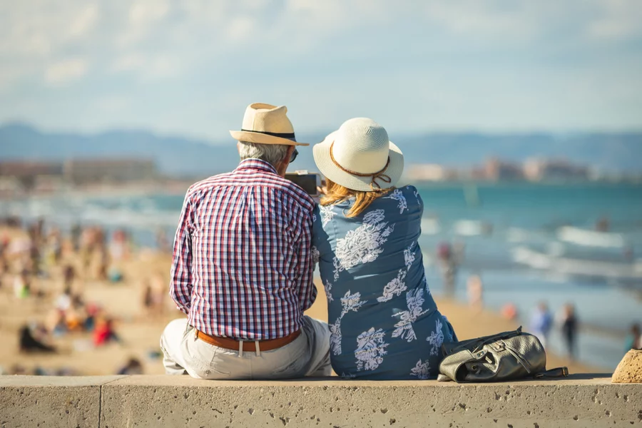 Mature couple of retired lovers enjoying retirement on the beach