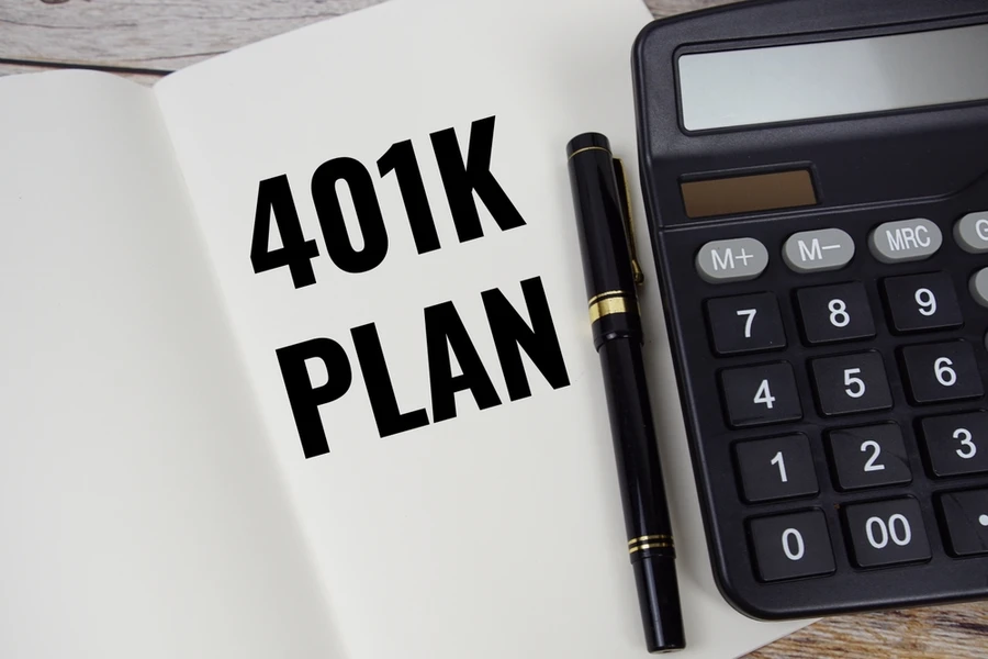 40k plan text on a book next to pen and calculator