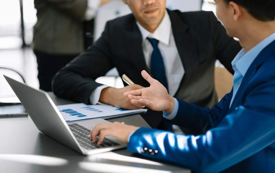 A businessman talking to a wealth manager.