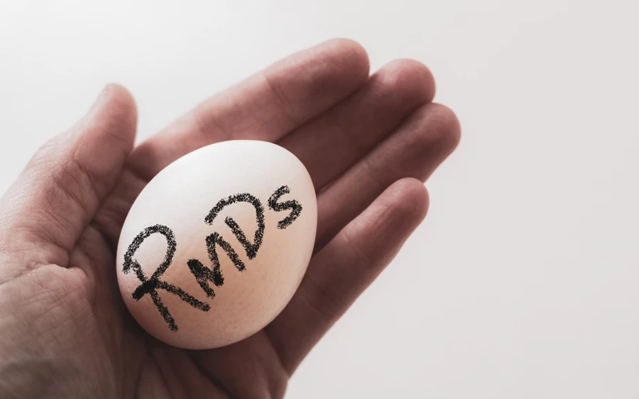 abstract hand holding nest egg metaphor retirement required minimum distributions