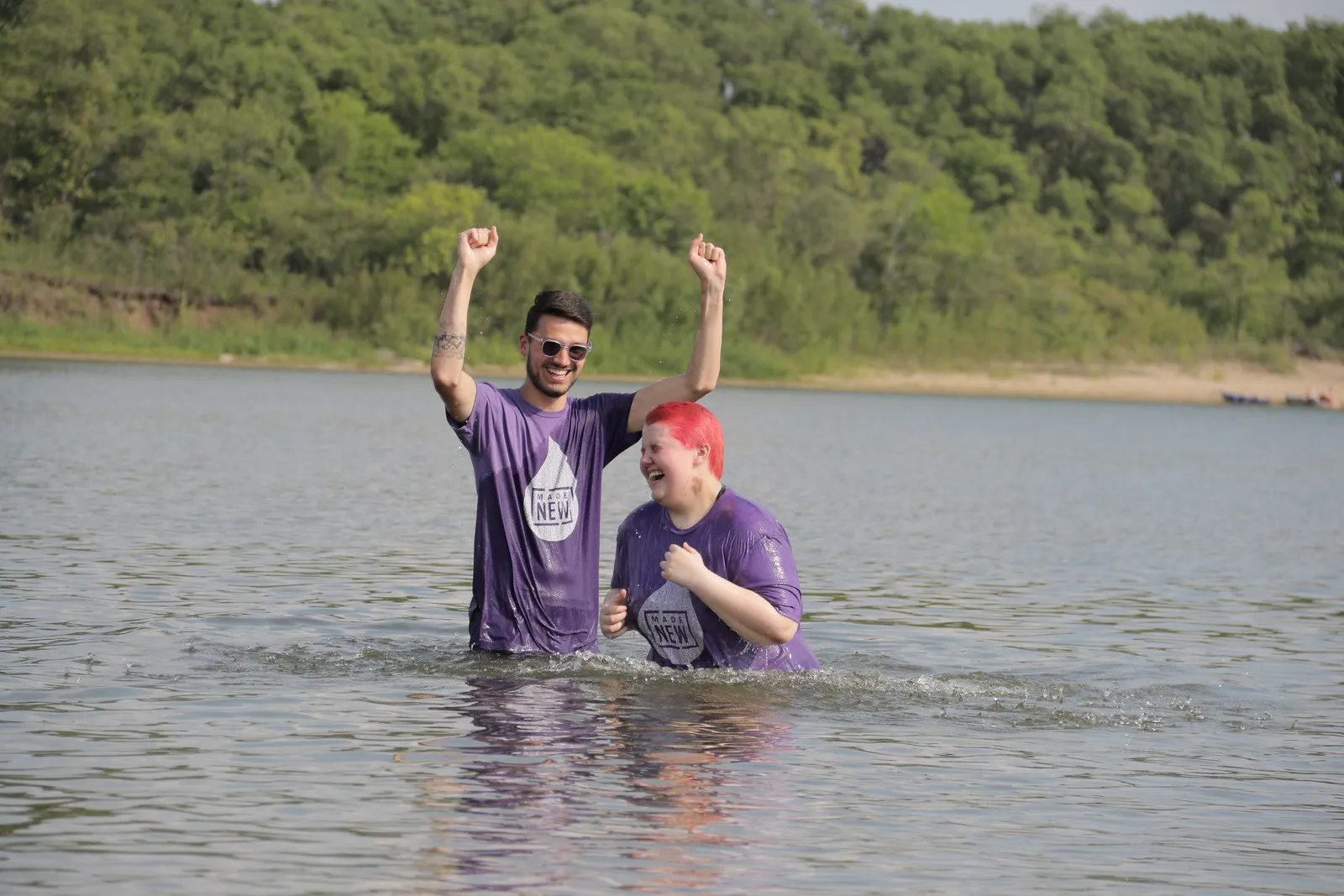 Ryan Allen, youth pastor, joyfully baptizing a young woman.
