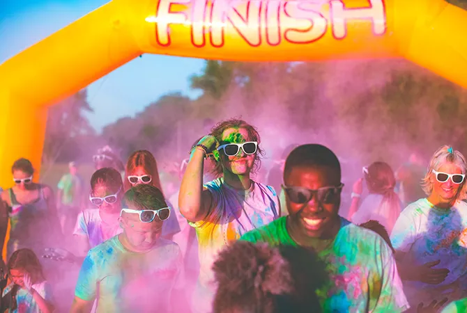 An image showing youth covered in colors during an event held at Reach Church.