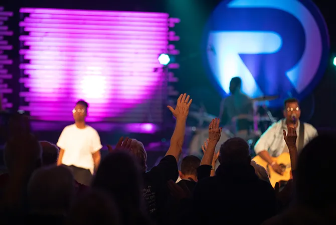 Photo of people singing at Reach Church