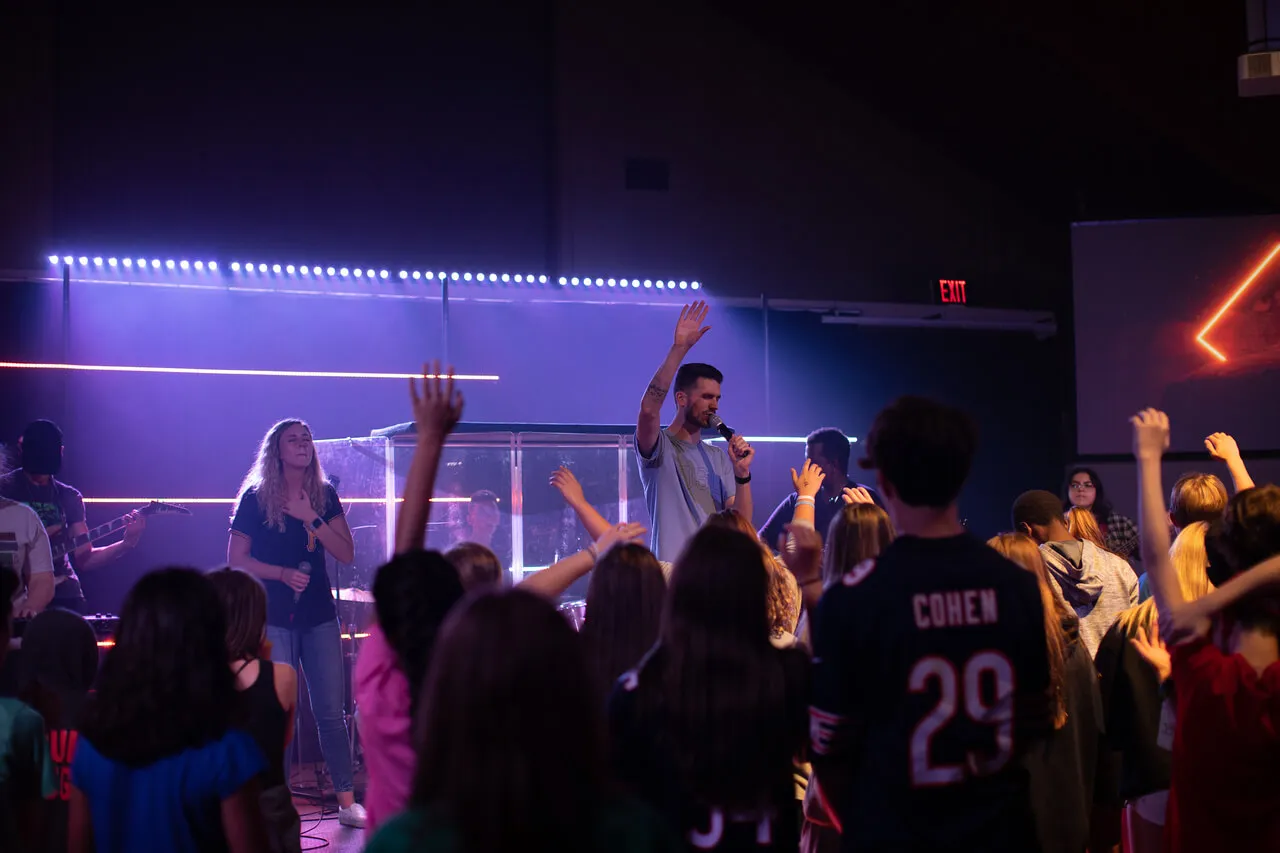 an image of young reach church students listening to a live worship service