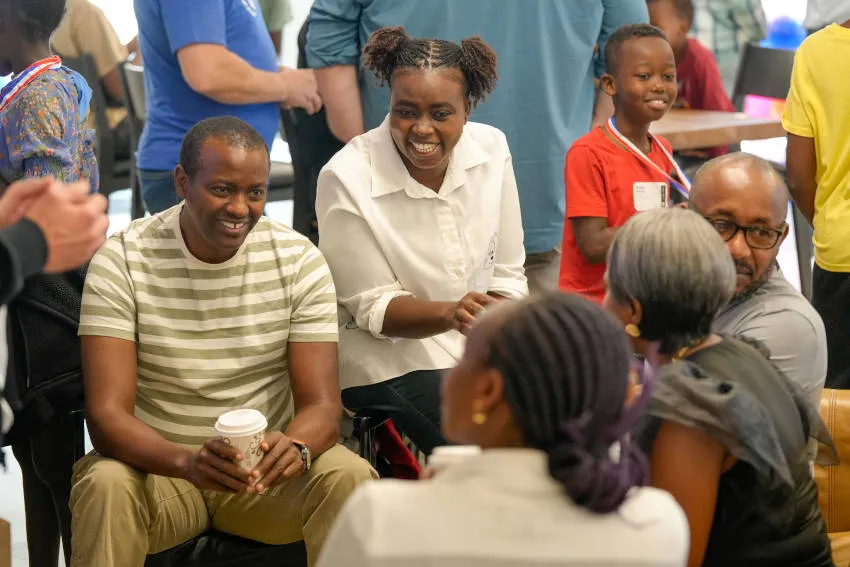 People laughing and having a conversation at Reach Church premises.