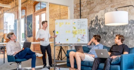 Marketing team planning a full-service influencer marketing program at a whiteboard