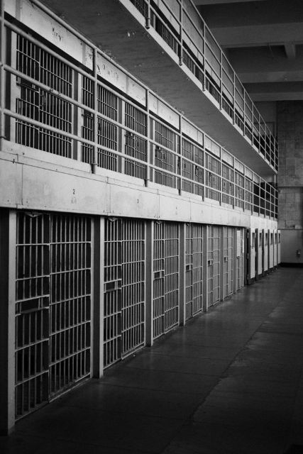 Empty jail cell block with steel bars