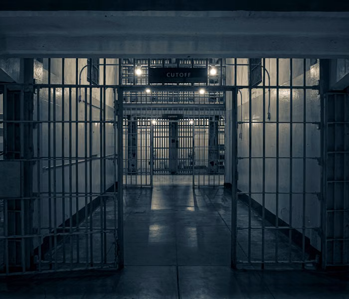Moody prison corridor with metal bars