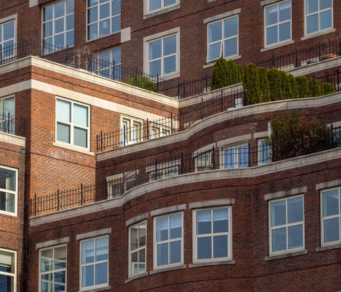 Red brick apartment building with terraces