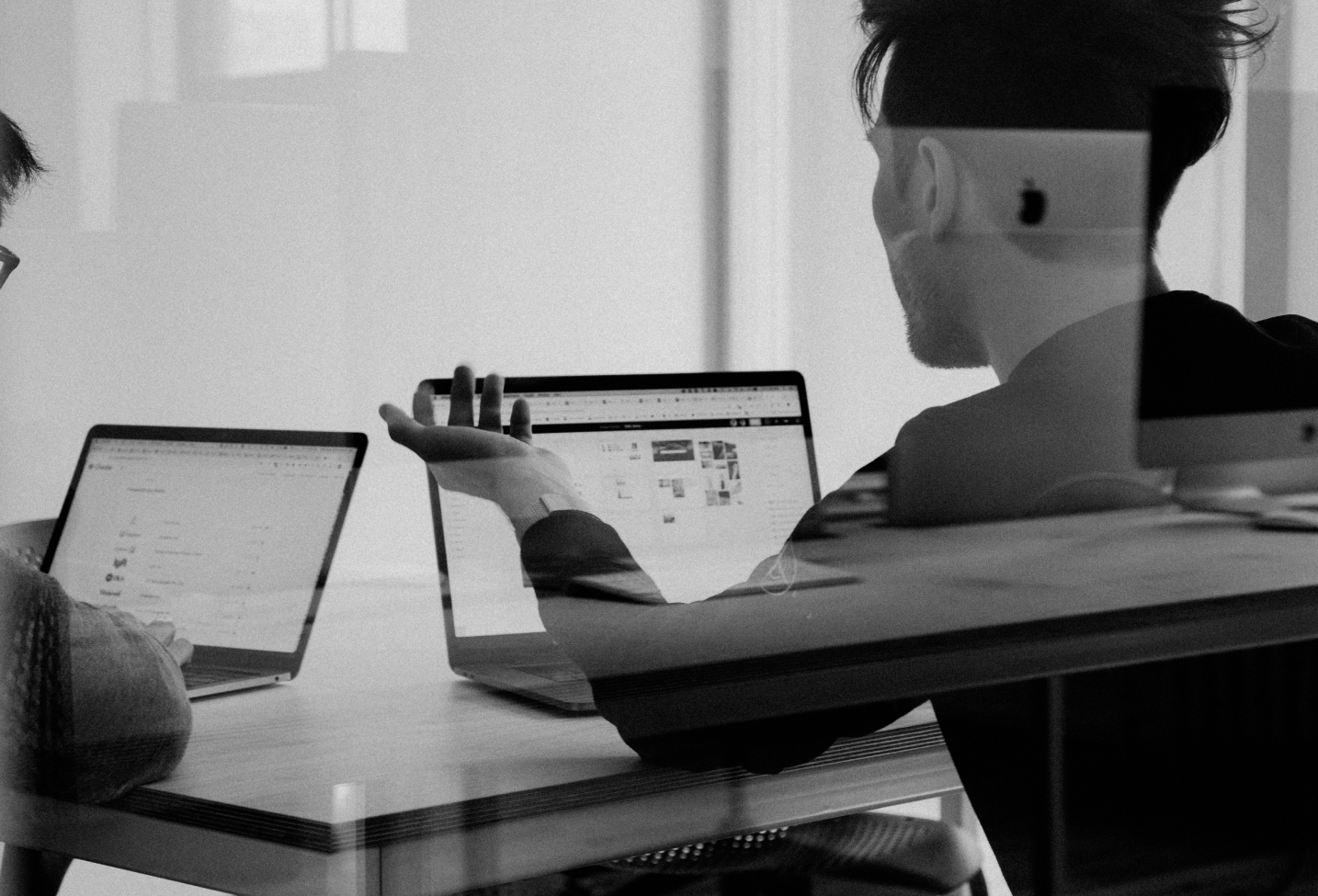 People working on computers discussing strategy