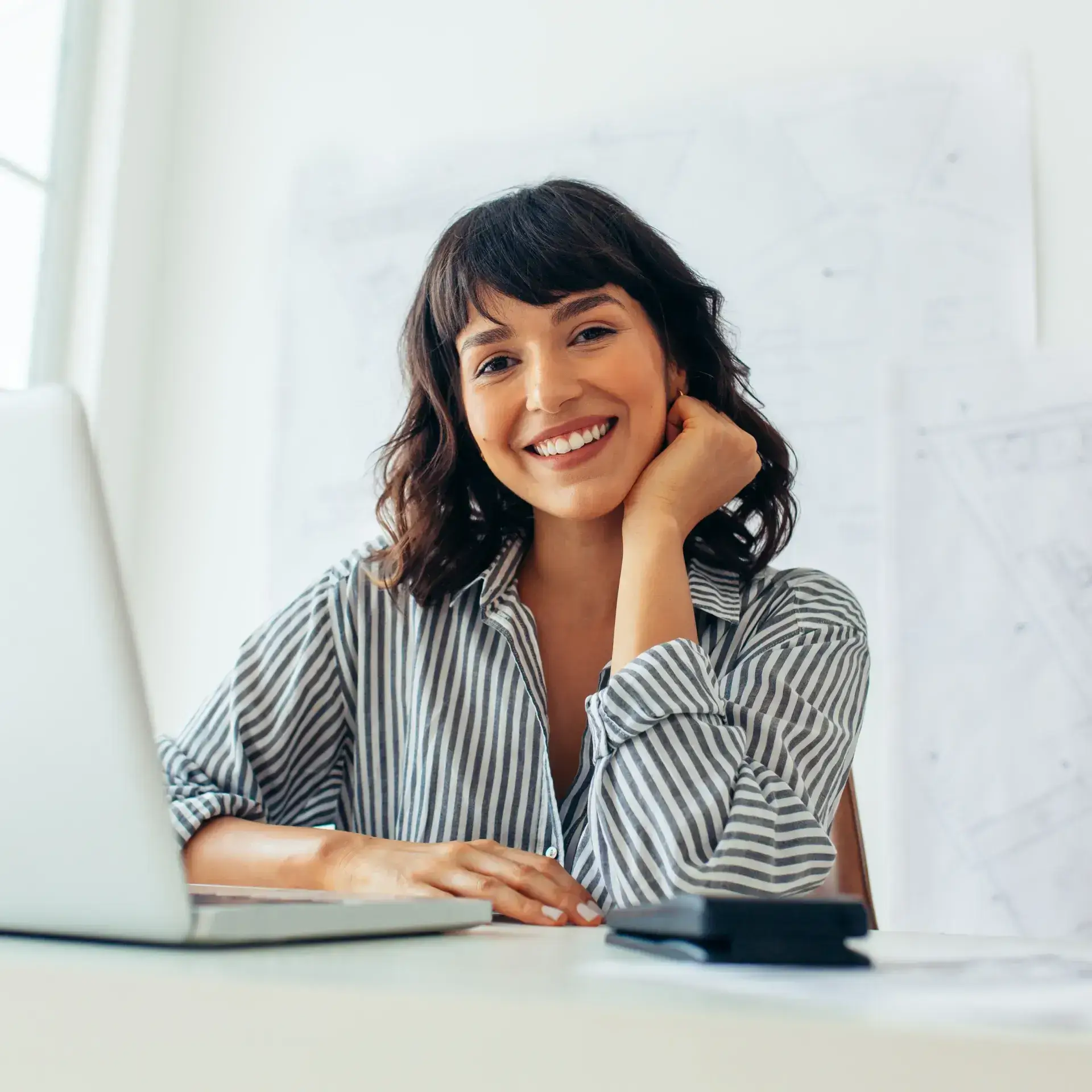 A woman sitting in front of a laptop computer.