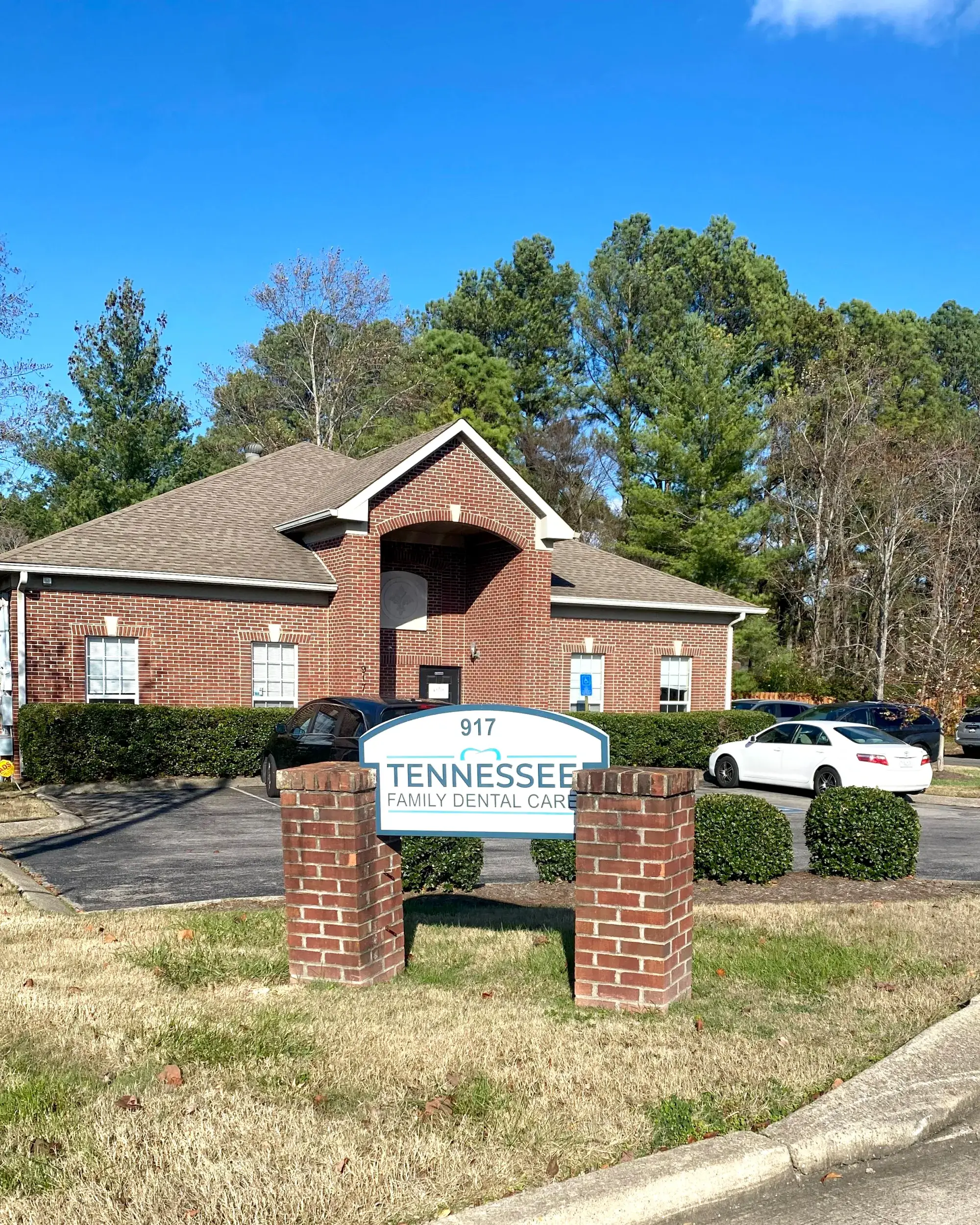 A brick building with a sign reading "Tennessee Family Dental Care" in front.