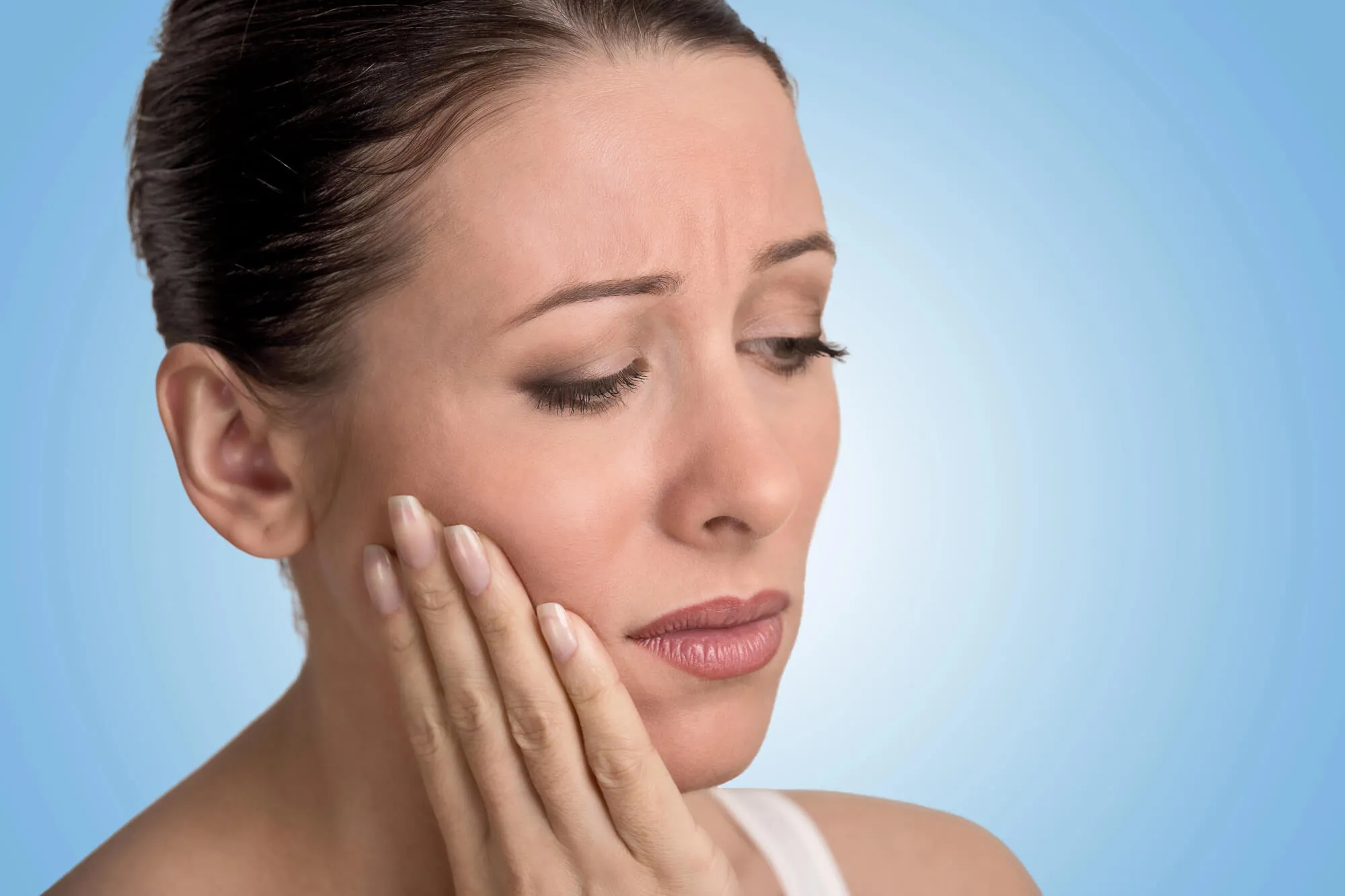woman with swollen gums needs gum disease treatment Issaquah