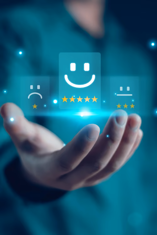 A person holding a smart device with a smiley face on it