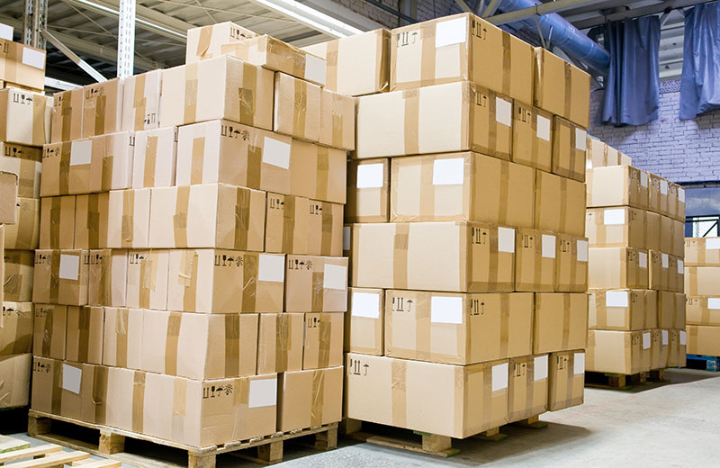 Stacked boxes on crates in a storage facility