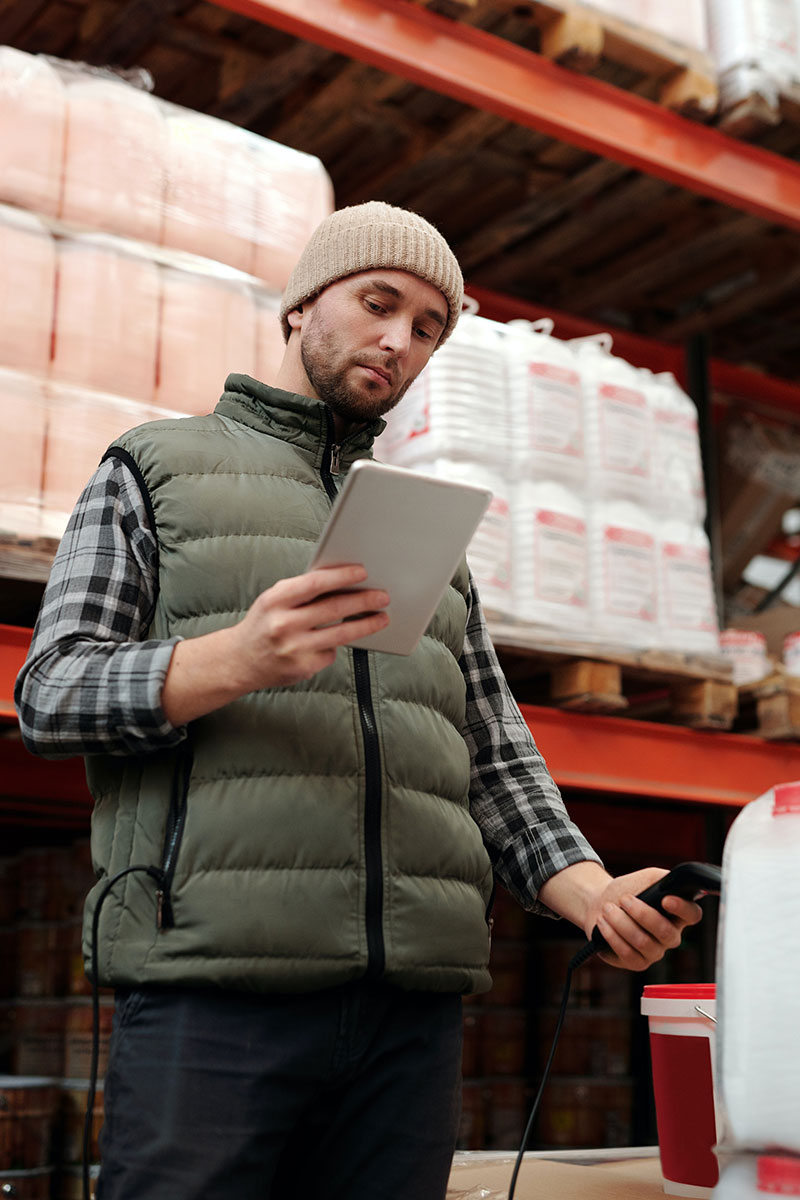Man scanning a product whilst looking down on an iPad