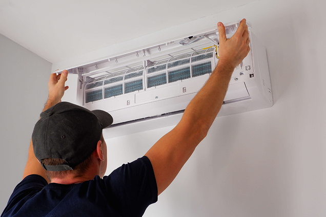 Modern loft space with wooden beams and Urban Cooling's loft air conditioning unit mounted on the wall.