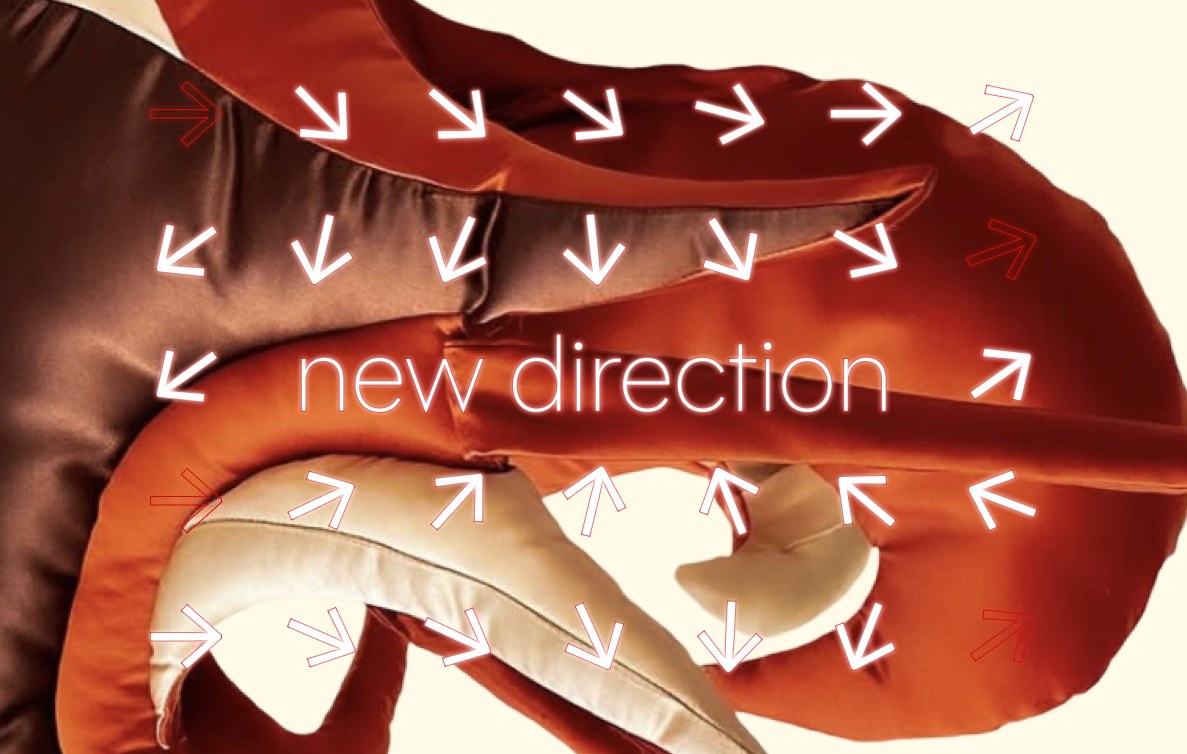 New direction arrows over a red garment