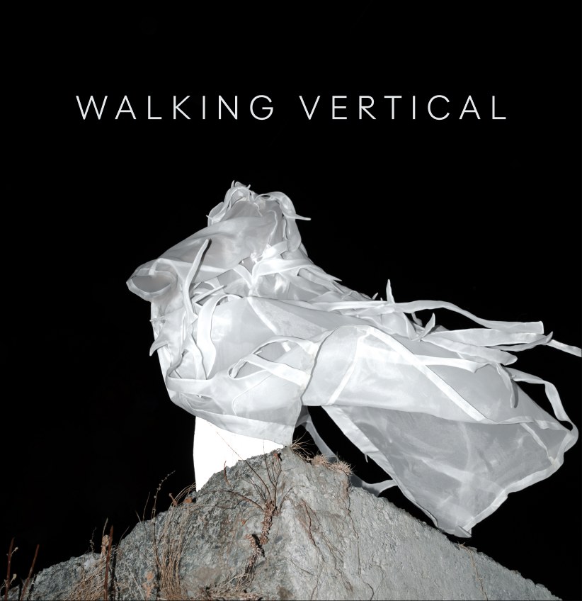 Walking Vertical white garment on a rock at night